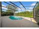Screened-in pool area overlooking a peaceful backyard lake view at 12510 Loquat Way, Tampa, FL 33626