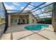 A relaxing screened-in pool and patio area with outdoor furniture at 12510 Loquat Way, Tampa, FL 33626