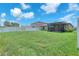 Large backyard with a screened lanai and privacy fencing at 12907 Wildflower Meadow Dr, Riverview, FL 33579