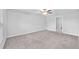 Spacious bedroom with neutral carpet, a ceiling fan, and an en suite bathroom at 12907 Wildflower Meadow Dr, Riverview, FL 33579