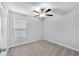 Bright bedroom boasts neutral carpet, a window, a ceiling fan, and a closet at 12907 Wildflower Meadow Dr, Riverview, FL 33579