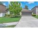 Charming single-story home with a well-maintained lawn, mature tree, and a two-car garage at 12907 Wildflower Meadow Dr, Riverview, FL 33579
