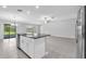 Open kitchen with a central island, stainless steel appliances, and seamless flow to dining area at 12907 Wildflower Meadow Dr, Riverview, FL 33579