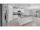 Modern kitchen features an island with a sink, granite countertops, and stainless steel appliances at 12907 Wildflower Meadow Dr, Riverview, FL 33579