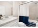 Bathroom with a modern vanity, and a bathtub featuring blue and white striped accents at 13157 Peachleaf Ave, Riverview, FL 33579