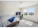 Cozy bedroom with modern decor, featuring a study desk and a large window providing natural light at 13157 Peachleaf Ave, Riverview, FL 33579