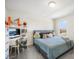 Well-lit bedroom featuring playful decor, a cozy bed, and a functional study area at 13157 Peachleaf Ave, Riverview, FL 33579