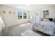 Inviting bedroom featuring blue floral bedding and natural light, creating a cozy retreat at 13157 Peachleaf Ave, Riverview, FL 33579