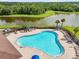 A view of the neighborhood community pool surrounded by lounge chairs at 13157 Peachleaf Ave, Riverview, FL 33579