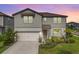 Charming two-story home with landscaped front yard and attached two-car garage at 13157 Peachleaf Ave, Riverview, FL 33579