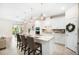 Bright, modern kitchen with white cabinetry, quartz countertops and stainless steel appliances at 13157 Peachleaf Ave, Riverview, FL 33579
