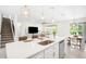 Spacious kitchen island featuring quartz countertops, stainless steel sink and modern fixtures at 13157 Peachleaf Ave, Riverview, FL 33579