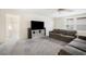 Spacious living room with plush gray carpeting, neutral walls, and a large TV setup at 13157 Peachleaf Ave, Riverview, FL 33579