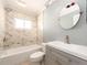 Bathroom featuring marble tiled shower over tub, and modern vanity at 14045 90Th Pl, Seminole, FL 33776