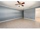 Spacious bedroom with neutral walls, tile flooring, and ceiling fan at 14045 90Th Pl, Seminole, FL 33776