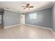 Empty bedroom with tile floors, ceiling fan, and ensuite bathroom at 14045 90Th Pl, Seminole, FL 33776