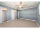 Bedroom with sliding closet doors, tile flooring, and ceiling fan at 14045 90Th Pl, Seminole, FL 33776