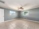 Bright bedroom with two windows, tile flooring, and a ceiling fan at 14045 90Th Pl, Seminole, FL 33776