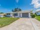 Attractive one-story home featuring a well-manicured lawn and long concrete driveway at 14045 90Th Pl, Seminole, FL 33776