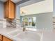 Stylish kitchen featuring modern countertops, white sink, and wood cabinetry at 14045 90Th Pl, Seminole, FL 33776