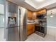 Modern kitchen featuring stainless steel refrigerator, oven, microwave, and wooden cabinets at 14045 90Th Pl, Seminole, FL 33776