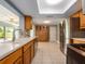 Spacious kitchen with stainless steel appliances, wooden cabinets, and view to the lanai at 14045 90Th Pl, Seminole, FL 33776