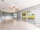 Open and airy lanai with tile floors, ceiling fans, and sliding glass doors at 14045 90Th Pl, Seminole, FL 33776