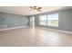 Bright living room featuring tile floors, base trim, and a large window at 14045 90Th Pl, Seminole, FL 33776