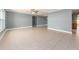 Spacious living room featuring neutral tile flooring, ceiling fan, and large windows at 14045 90Th Pl, Seminole, FL 33776