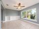 Sunlit living area with built-in shelving, tile floors, and large window with views at 14045 90Th Pl, Seminole, FL 33776