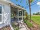 A screened porch featuring tile flooring with nice green backyard and landscaping at 14045 90Th Pl, Seminole, FL 33776
