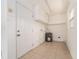 Utility room featuring tile floors, storage cabinets, and a water heater at 14045 90Th Pl, Seminole, FL 33776