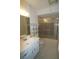 Bathroom with a single sink vanity and a shower/tub combination with gold framed sliding glass doors at 1406 Arrowhead W Cir, Clearwater, FL 33759