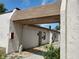 Exterior view of the townhouse complex featuring pedestrian access under a brown roof, and stone landscaping at 1406 Arrowhead W Cir, Clearwater, FL 33759