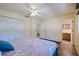 Bedroom with closet, ceiling fan, parquet flooring, and doorway to bathroom at 201 Westwood N Ter, St Petersburg, FL 33710