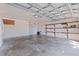 Spacious garage with ample storage, wooden shelving, and overhead door at 201 Westwood N Ter, St Petersburg, FL 33710