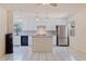 A renovated kitchen features white cabinetry, a center island, and stainless steel appliances at 201 Westwood N Ter, St Petersburg, FL 33710