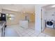 Open kitchen and living area features a kitchen island and updated appliances at 201 Westwood N Ter, St Petersburg, FL 33710