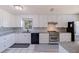 Modern kitchen with white cabinets, stainless steel appliances, and granite countertops at 201 Westwood N Ter, St Petersburg, FL 33710