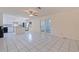Open concept living area features tile floors, a ceiling fan and sliding glass doors to the backyard at 201 Westwood N Ter, St Petersburg, FL 33710