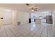 A bright, open-concept living area and kitchen features tile flooring and stainless steel appliances at 201 Westwood N Ter, St Petersburg, FL 33710