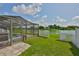 A backyard that overlooks the lake, complemented by a white picket fence, perfect for privacy and relaxation at 2021 Elk Spring Dr, Brandon, FL 33511