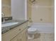Bathroom featuring granite counter, sink, toilet, and shower-tub combo at 2021 Elk Spring Dr, Brandon, FL 33511