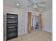 This bedroom has tile floors, a ceiling fan, and sliding glass doors to patio at 2021 Elk Spring Dr, Brandon, FL 33511