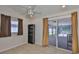 Bright bedroom with a ceiling fan, tile floors and sliding glass door to patio at 2021 Elk Spring Dr, Brandon, FL 33511
