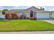 A charming home with a well-manicured front yard and colorful flowers, showcasing curb appeal at 2021 Elk Spring Dr, Brandon, FL 33511