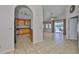 View of open kitchen with wood cabinetry and light-colored tile floors in an open floor plan at 2021 Elk Spring Dr, Brandon, FL 33511