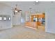 Spacious living room with light colored floors open to the kitchen with stainless steel appliances at 2021 Elk Spring Dr, Brandon, FL 33511