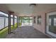 A covered patio with brick flooring, overlooking a tranquil lake, ideal for relaxation and outdoor dining at 2021 Elk Spring Dr, Brandon, FL 33511