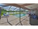 Covered backyard pool area overlooking the lake and featuring outdoor seating at 2021 Elk Spring Dr, Brandon, FL 33511